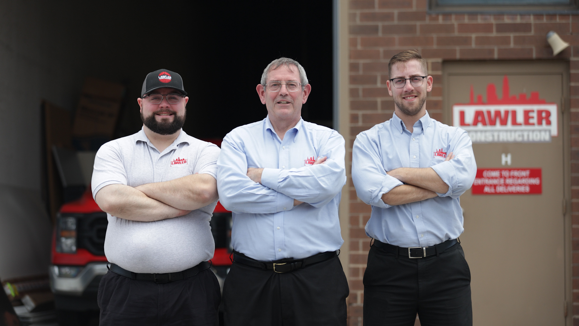 lawler president, controlloer, and scheduler standing in front of lawler construction